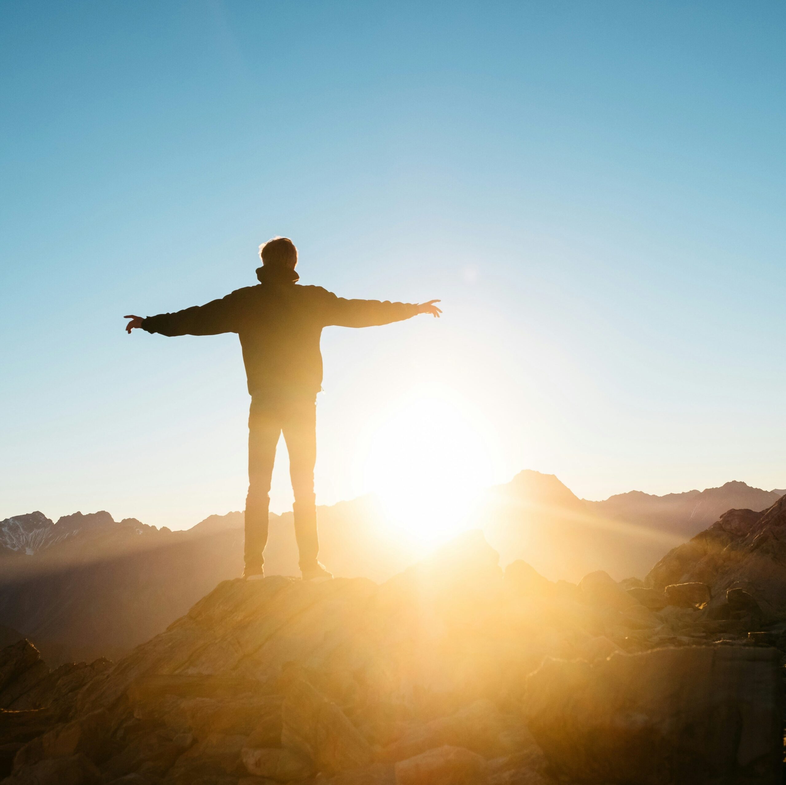 Man stading on top of moutain as a metaphor of leadership